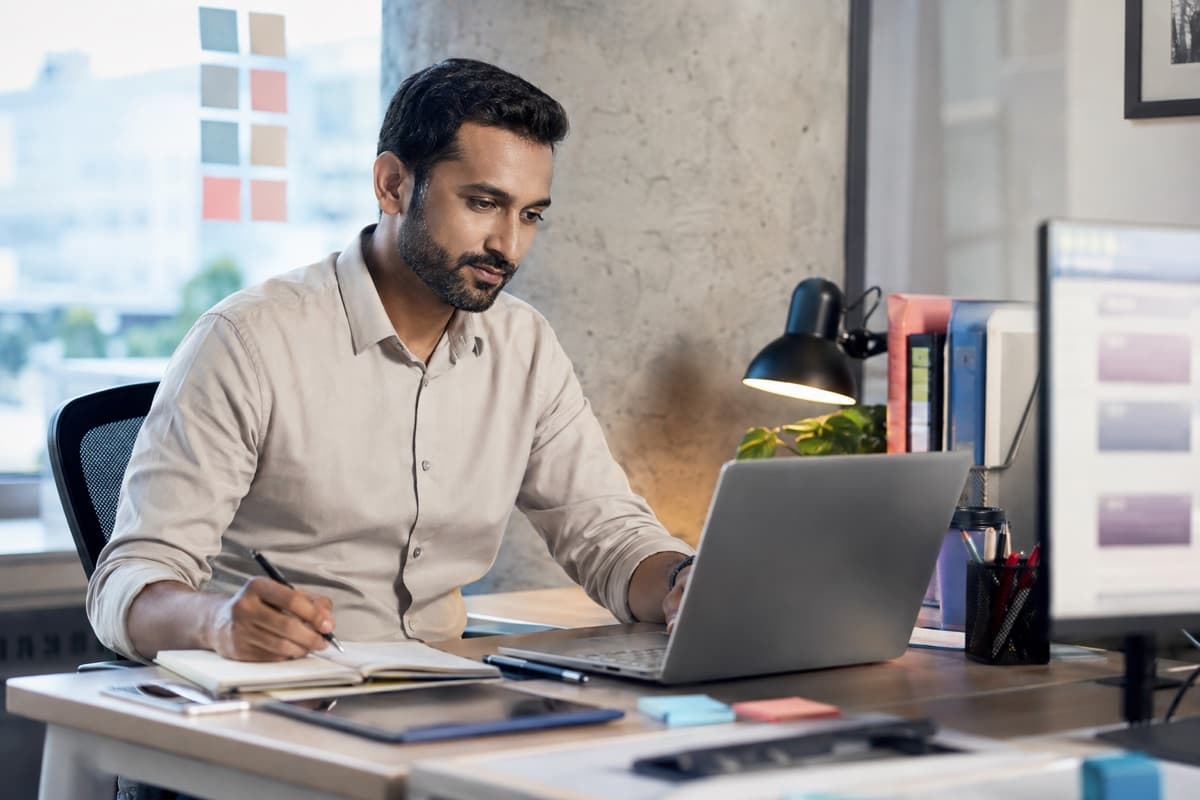 Business development professional reviewing and organizing new sales enquiries in a modern office
